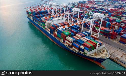 Aerial view port shipping, Container ship at port with crane port, Container ship carrying container import and export business logistic and transportation, Cargo freight shipping import export company.