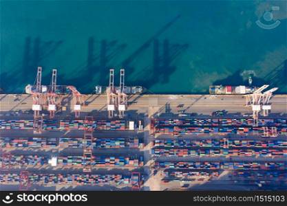 Aerial view sea port warehouse and container ship or crane ship working for delivery containers shipment. Suitable use for transport or import export to global logistics, Container ship in import export and business logistic, Container ship loading and unloading in deep sea port.