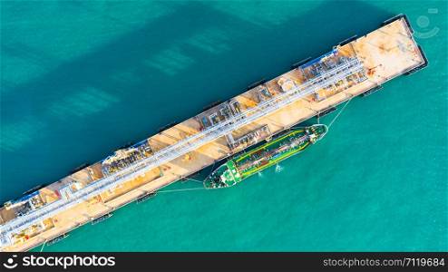 Aerial view tanker ship unloading at port, Business import export oil with tanker ship transportation oil from refinery on the sea.