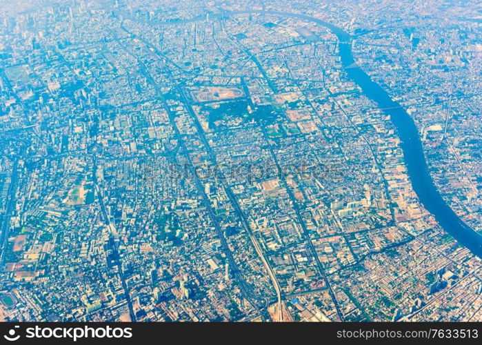 Aerial view to Bangkok Thailand downtown from a plane. Asian city from above