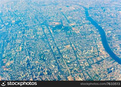 Aerial view to Bangkok Thailand downtown from a plane. Asian city from above