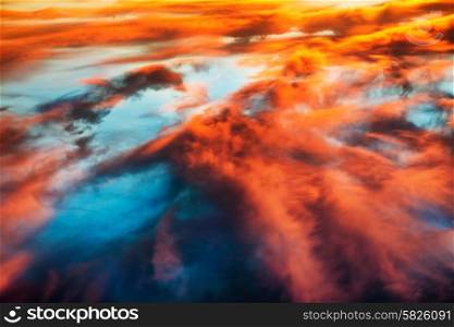 Aerial view to colorful orange and blue dramatic sky with clouds for abstract background