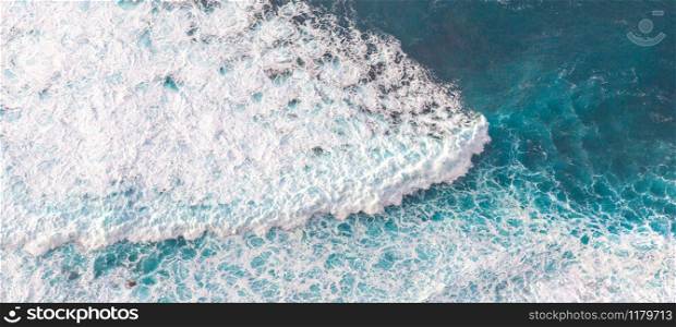 Aerial view to waves in ocean Splashing Waves. Blue clean wavy sea water.