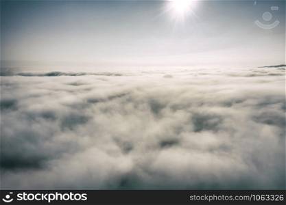 Aerial view white clouds in a blue sky. View from drone. Aerial bird's eye view. The texture of the clouds. View from above. Sunrise or sunset over clouds.