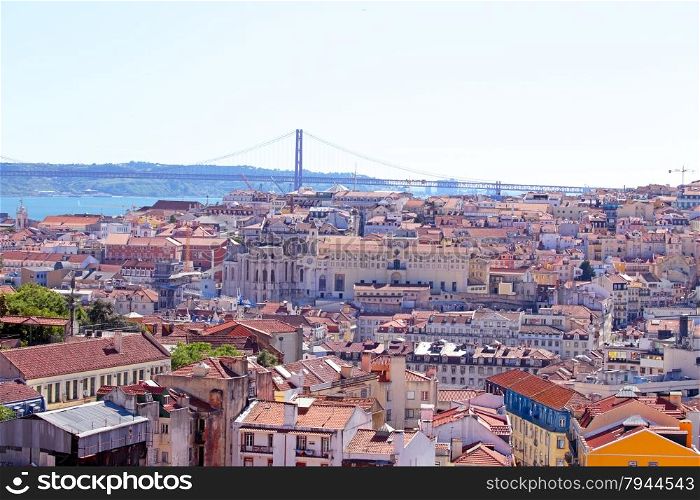 Aerial view with colored houses and the 25 abril bridge in Lisbon Portugal