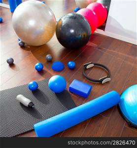 Aerobic Pilates stuff like mat balls roller magic ring rubber bands on wooden floor