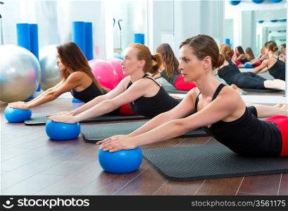 Aerobics pilates women with yoga balls in a row on fitness class
