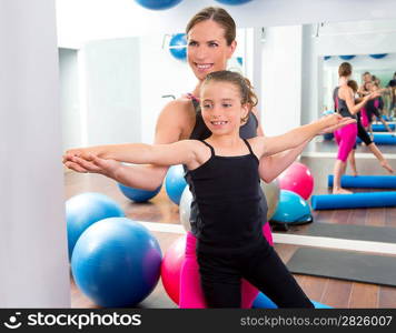 Aerobics woman personal trainer of children girl stability with foam roller