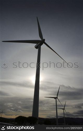 aerogenerator electric windmill on sunset cloudy sky