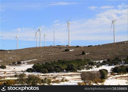 aerogenerator electric windmills on snow mountain