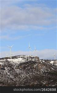 aerogenerator electric windmills on snow mountain