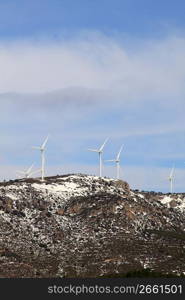 aerogenerator electric windmills on snow mountain