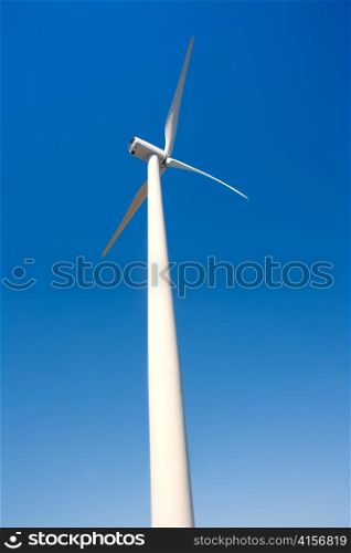 aerogenerator windmill in blue sky perspective background