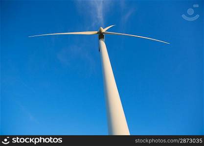 Aerogenerator windmills for green electric energy from below and ble sky background