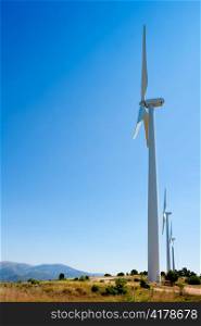 aerogenerator windmills in a row in blue sky day