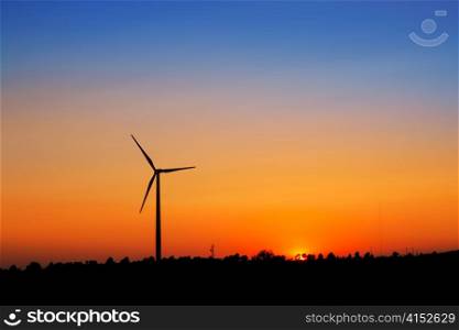 aerogenerator windmills on sunset sky background