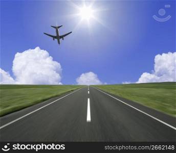 Aeroplane about to land on a runway on a sunny day