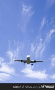 Aeroplane gliding through a cloudy blue sky
