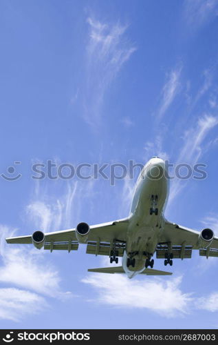 Aeroplane gliding through a cloudy blue sky