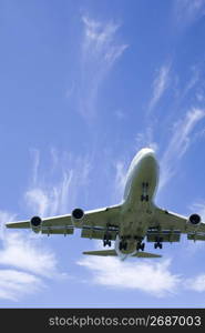 Aeroplane gliding through a cloudy blue sky