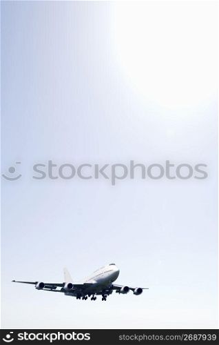 Aeroplane gliding through a cloudy white sky