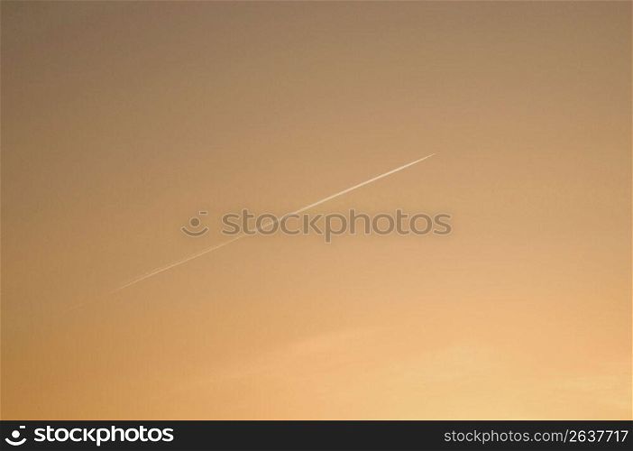 Aeroplane gliding through a sunset sky