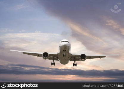 Aeroplane gliding through a sunset sky