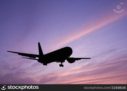 Aeroplane gliding through a sunset sky