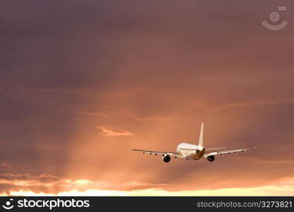 Aeroplane gliding through a sunset sky