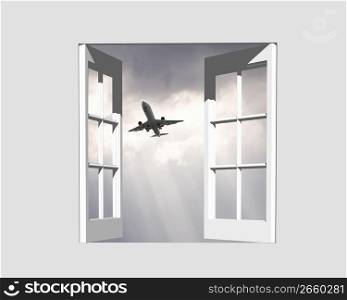 Aeroplane gliding through a sunset sky through a window frame