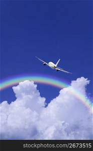 Aeroplane high in the sky with the sun shining brightly through a rainbow