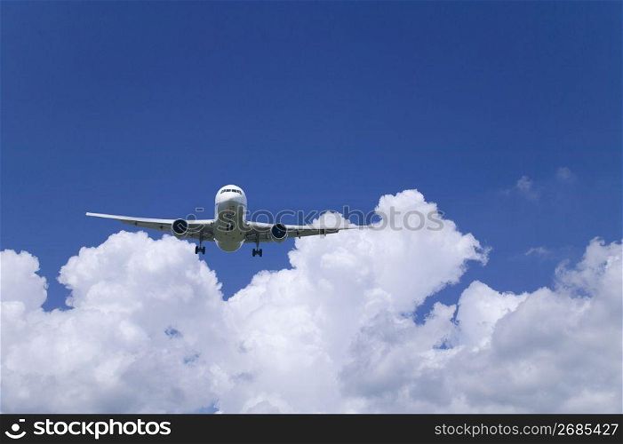 Aeroplane through a cloudy blue sky