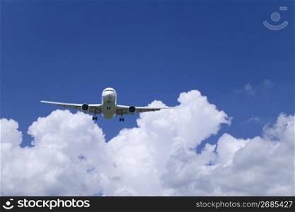 Aeroplane through a cloudy blue sky