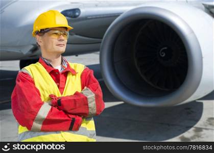 Aerospace engineer in front of the turbine of a commercial jet plane