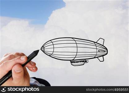Aerostat in sky. Person hand drawing aerostat on sky background