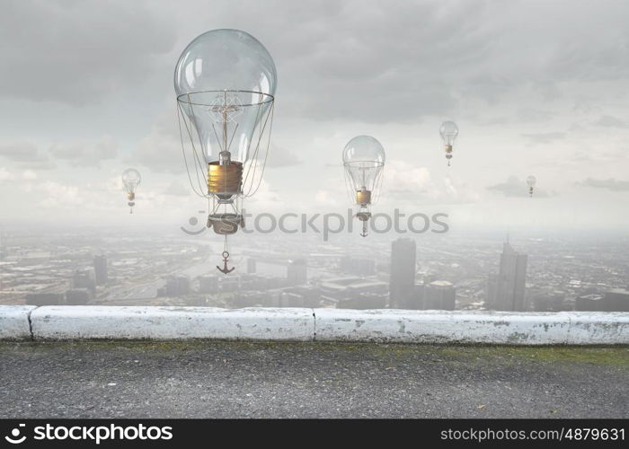 Aerostats flying over city. Colorful aerostats flying in clear sky above modern city