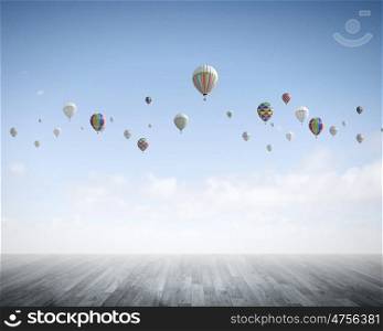 Aerostats in sky. Conceptual image with colorful balloons flying high in sky