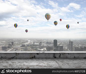 Aerostats in sky. Conceptual image with colorful balloons flying high in sky