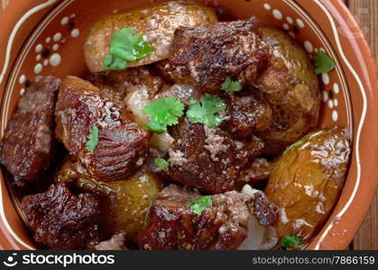 Afelia - a traditional Greek and Cypriot food. pork marinated and cooked in red wine