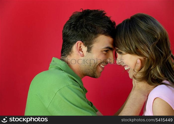Affectionate couple stood facing each other