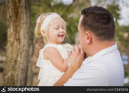 Affectionate Father Playing With Cute Baby Girl Outside at the Park.