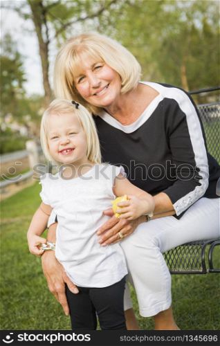 Affectionate Grandmother and Granddaughter Playing Outside At The Park.
