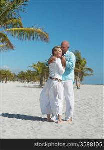 Affectionate senior couple on tropical beach