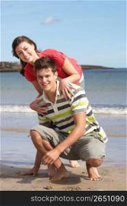 Affectionate Teenage Couple Having Fun On Beach