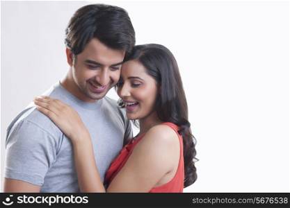 Affectionate young couple against white background