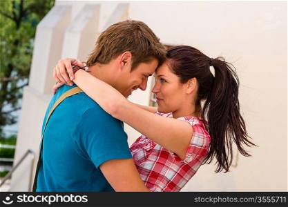 Affectionate young couple hugging looking at each other