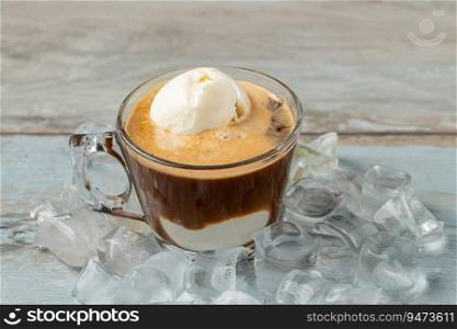 Affogato coffee with vanilla ice cream in a glass cup on wooden table