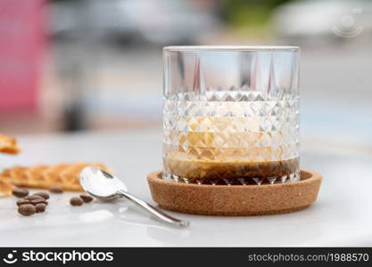 Affogato Coffee with vanilla ice cream in crystal glass on white marble table