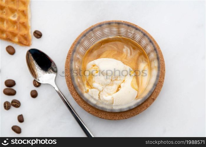 Affogato Coffee with vanilla ice cream in crystal glass on white marble table
