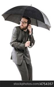 Afraid businessman hiding himself under the black umbrella